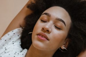 peaceful black woman with closed eyes