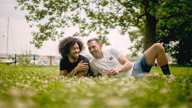 two men lying in grass