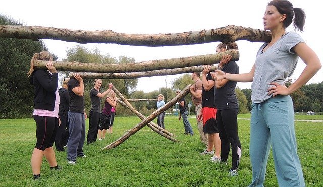 people holding logs in bootcamp