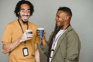 two black men wearing nametags