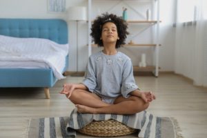 black girl meditating alone