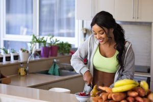 athletic black woman preparing healthy food