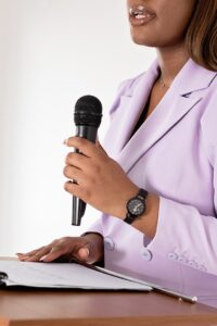 black woman holding a microphone-therapy for public speaking anxiety